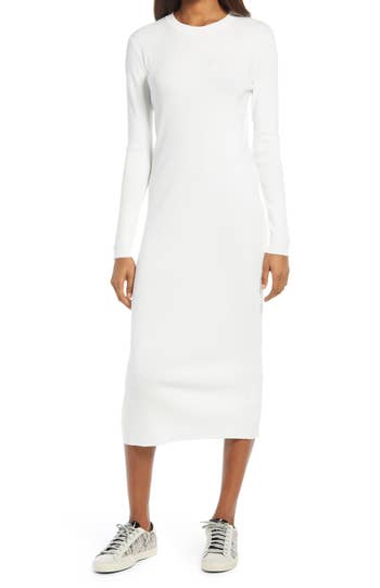 a model wearing a long sleeve midi dress in white 