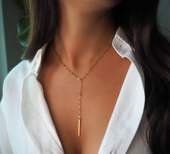 a model wearing the gold necklace