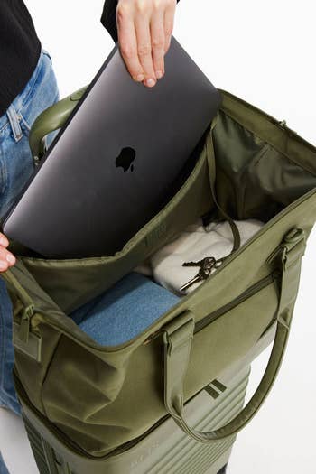 model pulling a macbook from the mini weekender