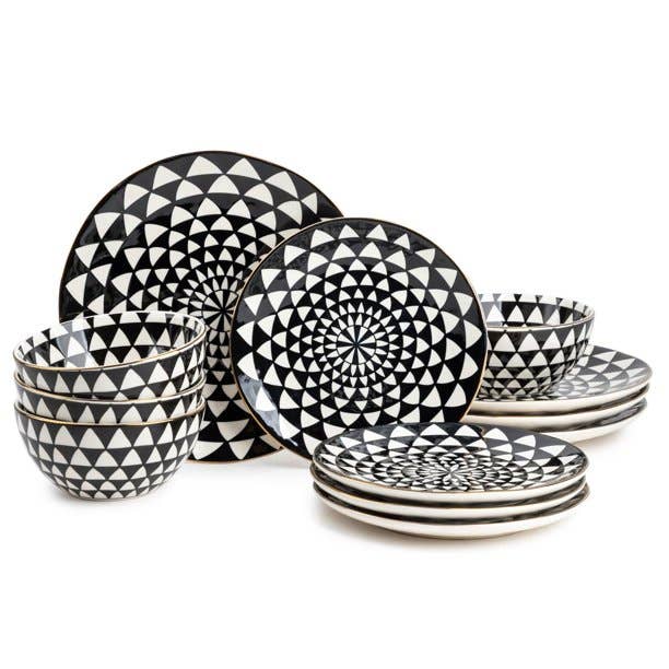 A set of black and white dishes including large plates, small plates, and bowls