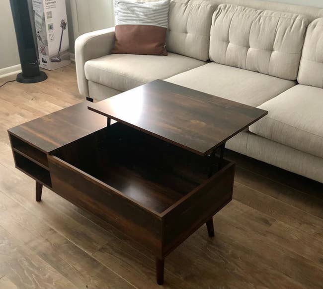 the retro brown lift top table in a living room