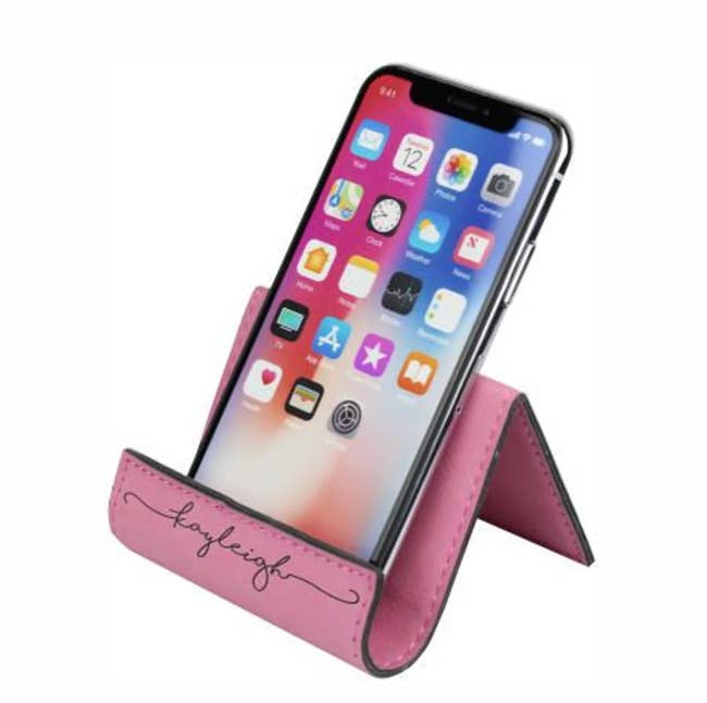 The phone holder in pink with the name 
