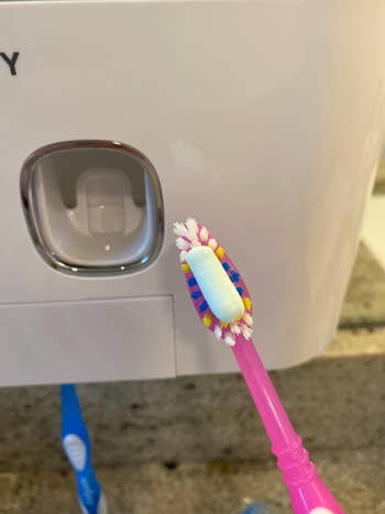 another reviewer's photo showing the toothpaste dispensed on the toothbrush