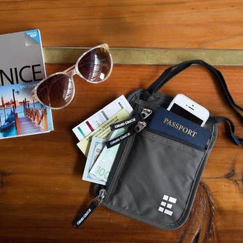 lifestyle photo of neck pouch passport holder with passport inside