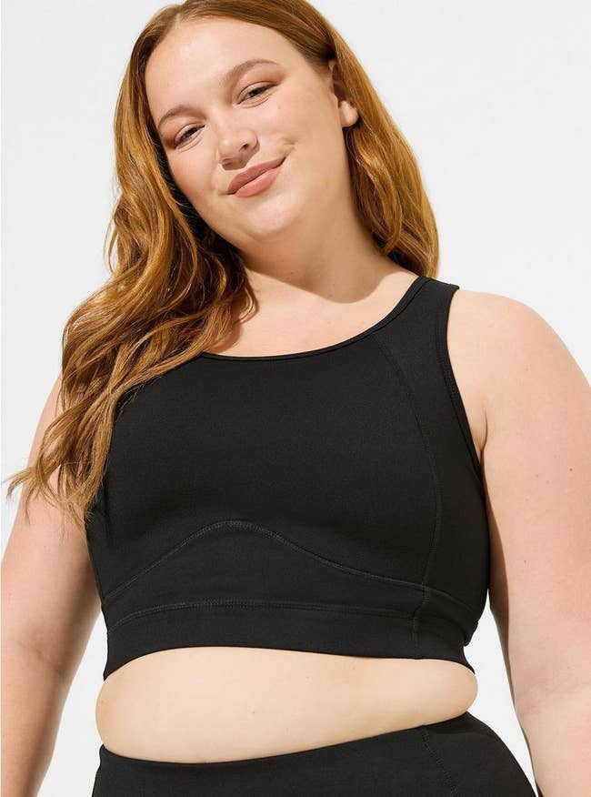 a model wearing the black sports bra