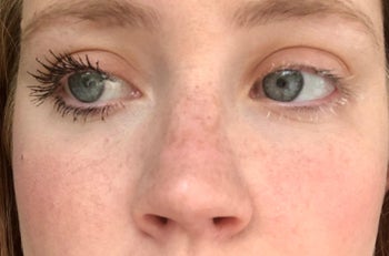 close-up of a reviewer wearing the mascara with more defined lashes on left eye compared to their right eye that doesn't have any mascara