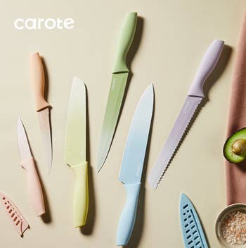 Various Carote room knives with pastel handles displayed with an avocado and salt. Suitable for culinary enthusiasts and location cooks