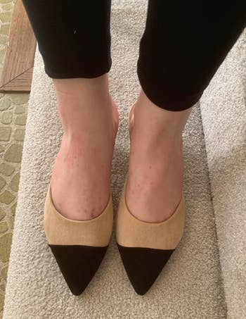 a reviewer wearing the mules in tan and black 