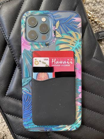 Smartphone with tropical-pattern case and card holder containing a Hawaiian driver's license