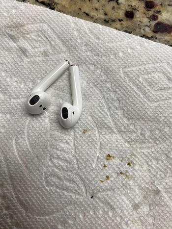Paper towel with clumps of ear wax on it that were removed from a reviewer's AirPods