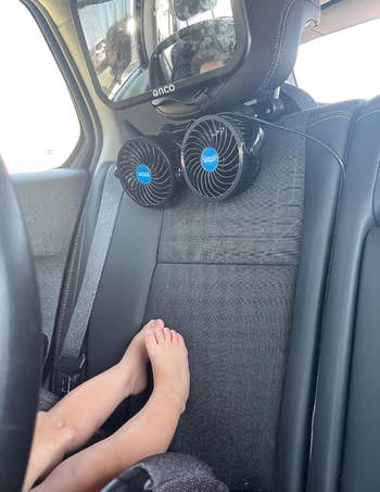 Back seat of a car with a reviewer's child's feet visible
