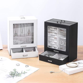 white and black display jewelry cases, showing compartments