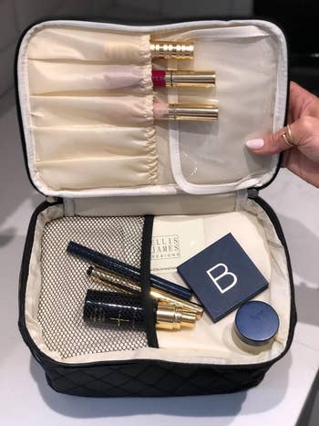 reviewer photo with makeup in travel makeup bag compartments