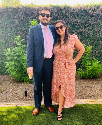 writer wearing orange dress and black heels