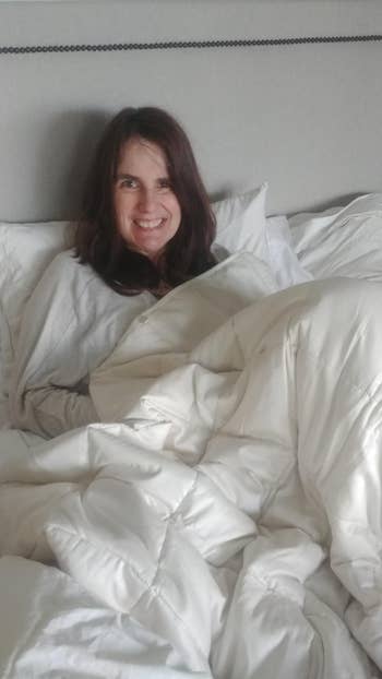 reviewer photo smiling under white weighted blanket