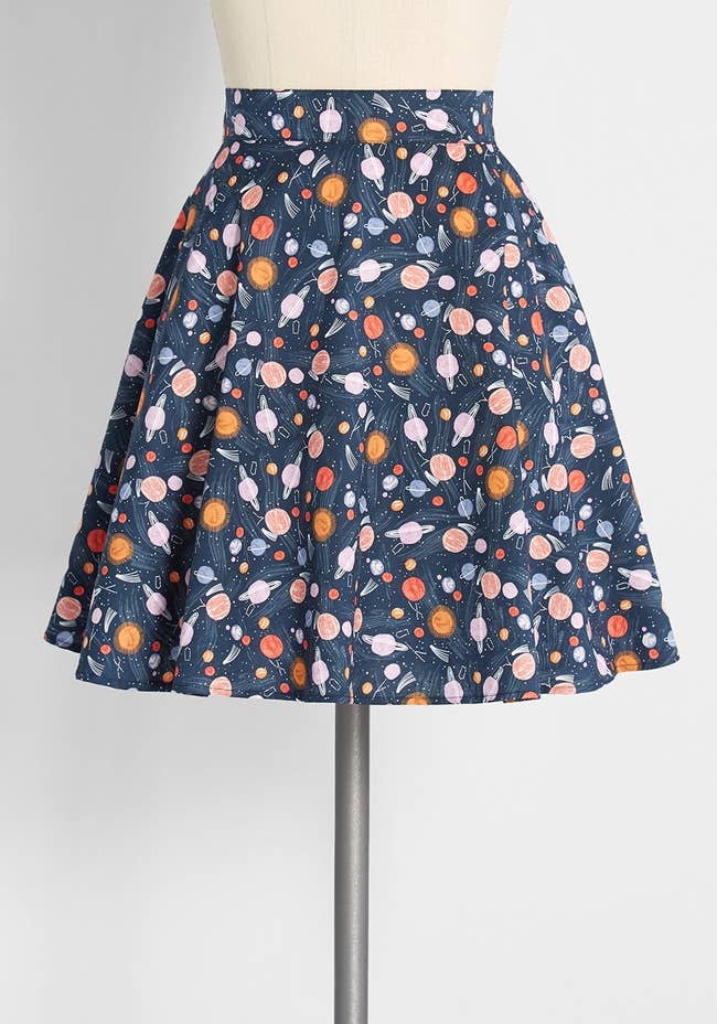 a navy blue skirt with a pattern of planets all over it