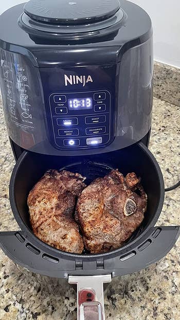 A reviewer's air fryer filled with meat