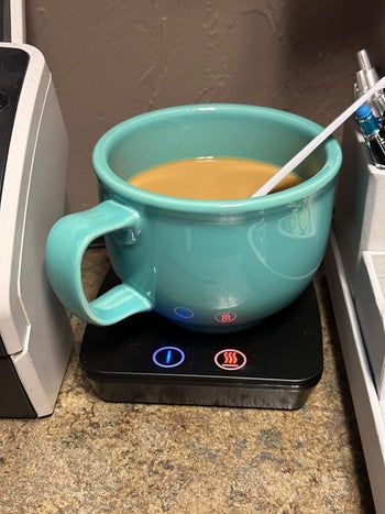 Reviewer's coffee on their black mug warmer