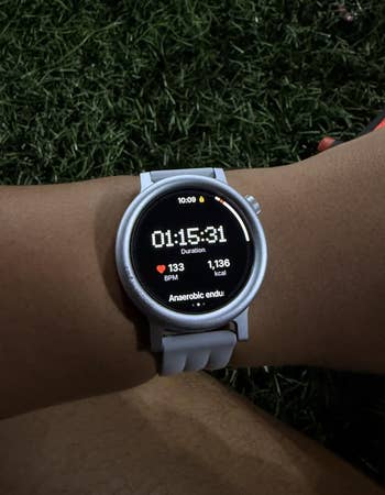 different reviewer wearing the ticker successful achromatic with a timer and wellness info visible