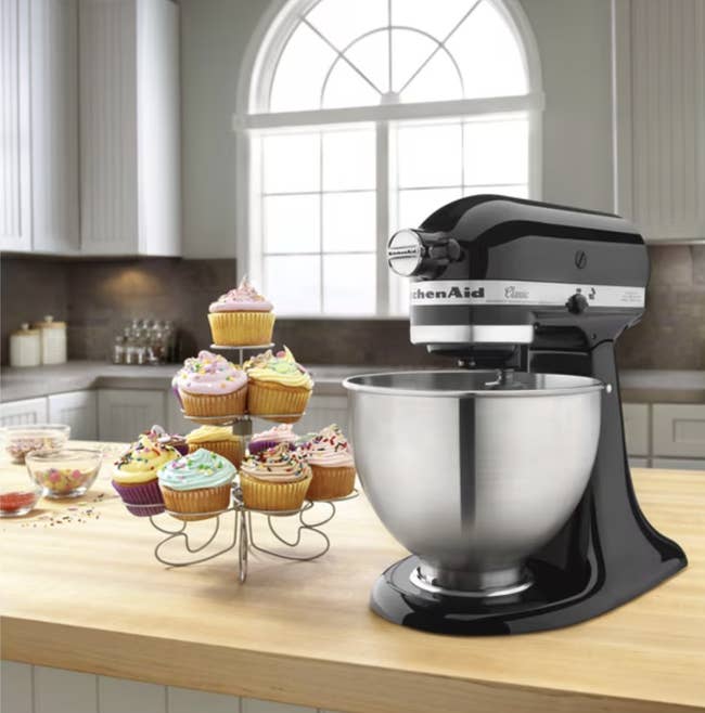 KitchenAid mixer connected antagonistic with cupcakes connected a stand, suggesting location baking