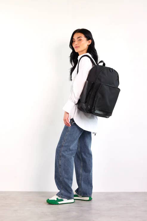 model wearing a black backpack