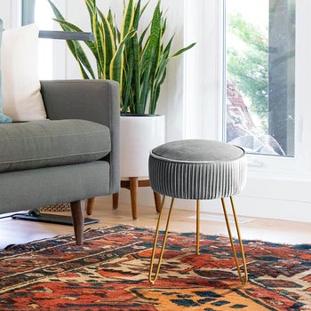 the gray footstool in a living room
