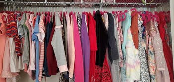 reviewer image of a closet full of girl's clothes hanging on pink kids hangers