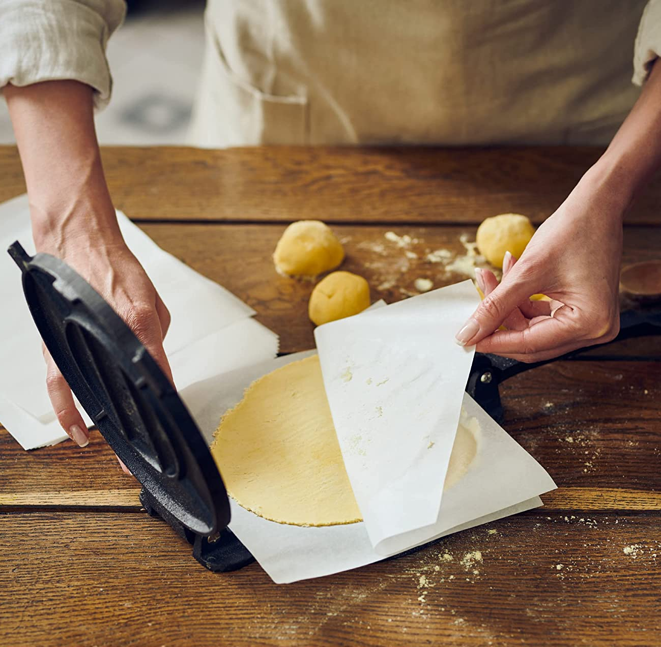 hands using the tortilla press to make homemade tortillas