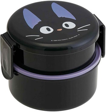 round black containers that lock together with jiji face on lid