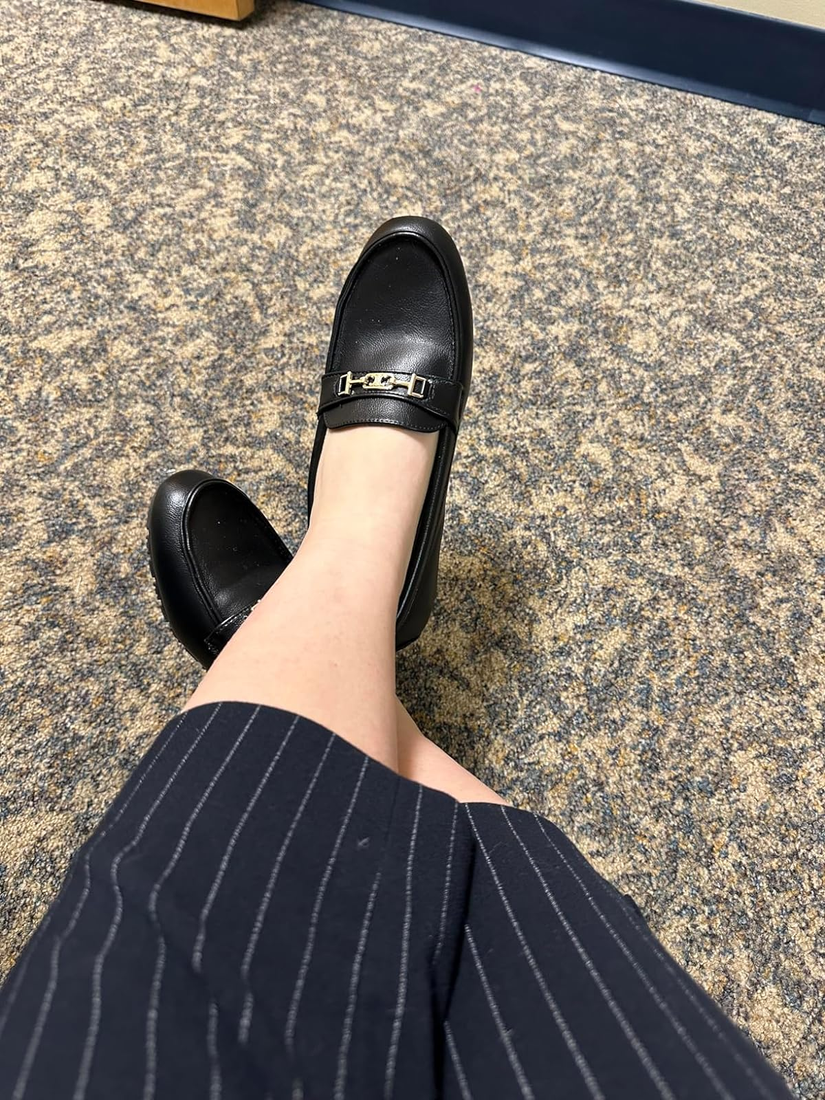 Person wearing a striped garment with a black, buckled shoe, suitable for a professional setting