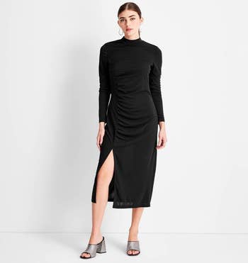 a model wearing the same dress in black 