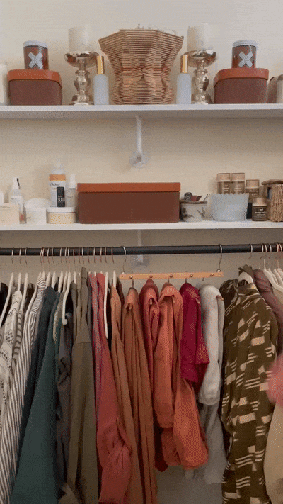 gif of my closet with several pairs of pants on the hanger. first it is horizontal and then it is adjusted to hold the pants vertically. 