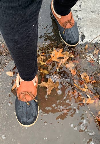 reviewer wearing the shoes through a puddle