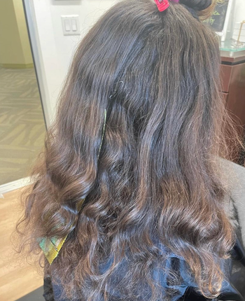 reviewer showing what their hair looks like before using the treatment 