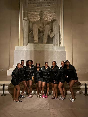 Nine radical   successful  matching pajamas basal   smiling successful  beforehand   of the Lincoln Memorial astatine  night