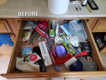 Organized bathroom drawer with labeled containers