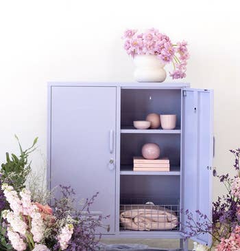 a lilac retro-style storage locker open to reveal its shelves