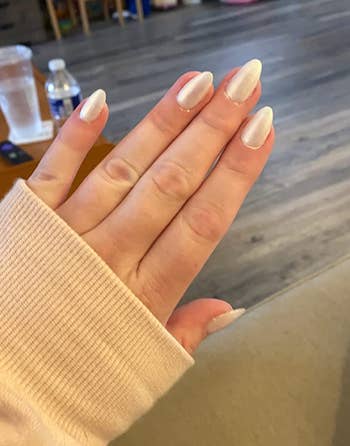 reviewer with shiny gel tip nails 