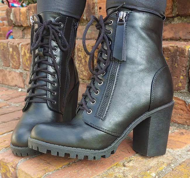 Reviewer in black heeled lace-up boots with side zippers