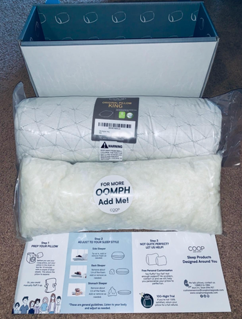 A package with a rolled up pillow and separate memory foam that can be added to the pillow 
