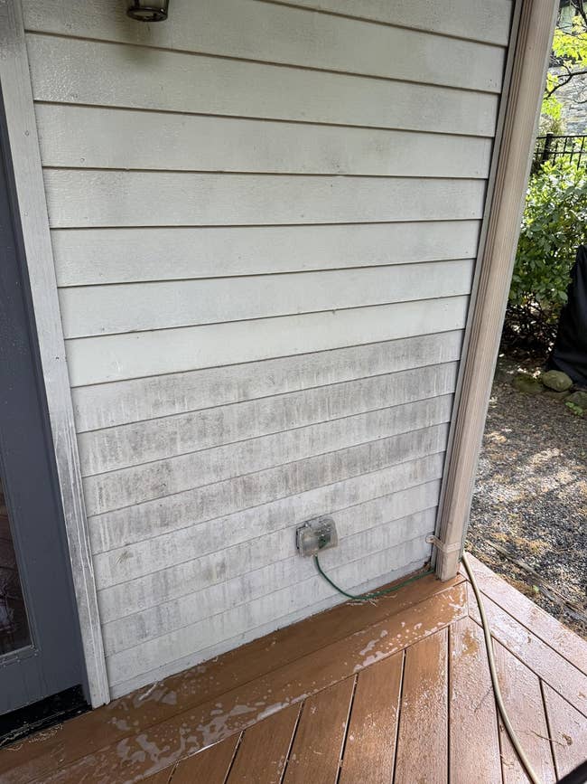 A partially cleaned outdoor partition showing powerfulness washing results, evident from the cleaner conception connected the near compared to the soiled close side