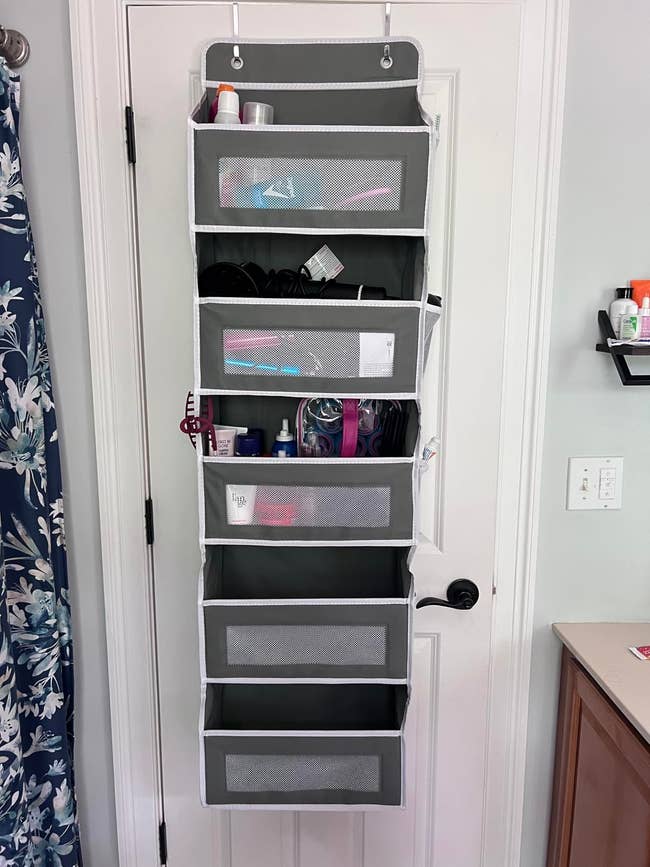 Hanging doorway organizer with mesh pockets