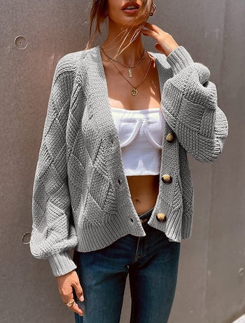 model wearing the gray version open with a cropped tank top underneath