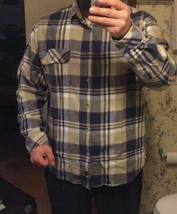 reviewer wearing the flannel buttoned up 