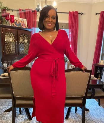 Reviewer in red v-neck sweater dress with tie waist 