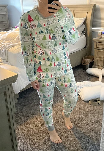 a reviewer in light green striped pajamas with christmas trees on them