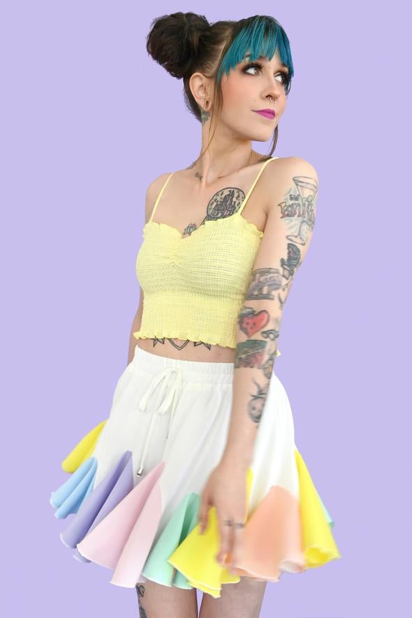 white skirt with circular pleated fabric in different colors sewn in to the bottom