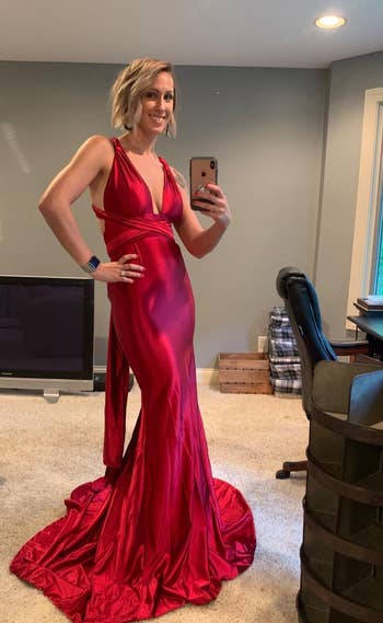 A reviewer wearing the dress in red 