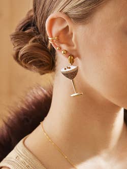 model in espresso martini earrings