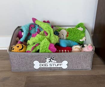 reviewer's grey bin full of dog toys